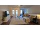 Spacious living room includes hardwood floors, modern furnishings, and sliding glass doors leading to an outdoor area at 14214 Fredricksburg Dr # 106, Orlando, FL 32837