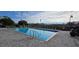 Community pool featuring lounge chairs, brick pavers, and lush landscaping at 14214 Fredricksburg Dr # 106, Orlando, FL 32837