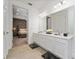 Bright bathroom features double vanity and a view of the bedroom at 1432 Reunion Blvd, Reunion, FL 34747