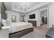 Main bedroom with king-size bed and ensuite bathroom at 1432 Reunion Blvd, Reunion, FL 34747