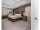 Main bedroom with large bed and modern chandelier at 1432 Reunion Blvd, Reunion, FL 34747