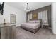 Main bedroom with king-size bed and large mirror at 1432 Reunion Blvd, Reunion, FL 34747