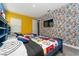 Twin beds in a bedroom with a comic book wall at 1432 Reunion Blvd, Reunion, FL 34747
