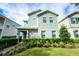 Two-story house with light blue siding, stone accents, and a landscaped front yard at 1432 Reunion Blvd, Reunion, FL 34747