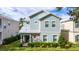 Two-story house with light blue siding, stone accents, and a landscaped front yard at 1432 Reunion Blvd, Reunion, FL 34747