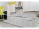 Sleek kitchen featuring white shaker cabinets, stainless steel appliances, and white quartz countertops at 1432 Reunion Blvd, Reunion, FL 34747