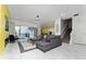 Spacious living room featuring a large sectional sofa, fireplace, and sliding doors to the pool at 1432 Reunion Blvd, Reunion, FL 34747