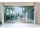 Sliding glass doors open to a view of a private pool and fenced backyard at 1432 Reunion Blvd, Reunion, FL 34747
