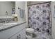 Clean bathroom with granite countertop and patterned shower curtain at 1836 Delrose Rd, Kissimmee, FL 34744