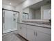 Modern bathroom with double vanity, granite countertop, and walk-in shower at 1836 Delrose Rd, Kissimmee, FL 34744