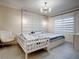 Spacious bedroom with large bed, additional sleeping space, and stylish lighting at 1836 Delrose Rd, Kissimmee, FL 34744