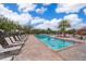 Inviting community pool with lounge chairs and palm trees at 1836 Delrose Rd, Kissimmee, FL 34744