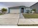 Curb appeal abounds at this charming one-story home, featuring a landscaped yard and two-car garage at 1836 Delrose Rd, Kissimmee, FL 34744