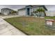 Landscaped front yard with a walkway leading to the entrance of the home at 1836 Delrose Rd, Kissimmee, FL 34744