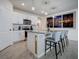 Modern kitchen with white cabinets, granite island, and stainless steel appliances at 1836 Delrose Rd, Kissimmee, FL 34744