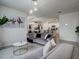 Comfortable living room with sectional sofa and view into the kitchen at 1836 Delrose Rd, Kissimmee, FL 34744