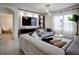 Open living room with sectional sofa, built-in media wall, and large TV at 1836 Delrose Rd, Kissimmee, FL 34744