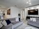 Open living room with sectional sofa and view into kitchen at 1836 Delrose Rd, Kissimmee, FL 34744