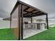 Covered patio with outdoor kitchen and ceiling fan at 1836 Delrose Rd, Kissimmee, FL 34744