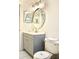 Modern bathroom with gray vanity and round mirror at 2035 Royal Bay Blvd # 45, Kissimmee, FL 34746