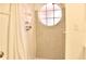 Clean bathroom with shower, tiled walls, and a circular window at 2035 Royal Bay Blvd # 45, Kissimmee, FL 34746