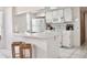 White kitchen boasts a breakfast bar with seating and modern appliances at 2035 Royal Bay Blvd # 45, Kissimmee, FL 34746