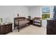 Bedroom with crib, changing table, and decor at 2106 Crystal Bell St, Orlando, FL 32824