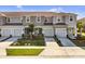 Aerial view of three-unit townhouse building with gray siding and attached garages at 2106 Crystal Bell St, Orlando, FL 32824