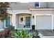 Townhouse exterior featuring a gray facade, two-car garage, and landscaping at 2106 Crystal Bell St, Orlando, FL 32824