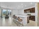 Modern kitchen with dark cabinetry, white countertops, and island seating at 2106 Crystal Bell St, Orlando, FL 32824