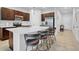 Open kitchen with dark wood cabinets, quartz countertops, and stainless steel appliances at 2106 Crystal Bell St, Orlando, FL 32824