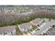 Aerial view of townhome community with pond, surrounded by trees at 2559 Sedge Grass Way, Orlando, FL 32824