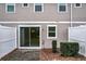 Enclosed back patio with sliding glass doors, privacy fence, and a stone paver patio at 2559 Sedge Grass Way, Orlando, FL 32824