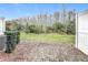 Private backyard space featuring a wooded view, green lawn, and brick patio at 2559 Sedge Grass Way, Orlando, FL 32824