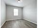 Small empty bedroom with gray floors and a window to allow plenty of natural light at 2559 Sedge Grass Way, Orlando, FL 32824