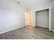 Bedroom with gray floors features an open closet and a doorway leading to another room at 2559 Sedge Grass Way, Orlando, FL 32824