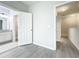 Neutral bedroom featuring gray floors, light walls, open door to a walk-in closet, and an adjacent bathroom at 2559 Sedge Grass Way, Orlando, FL 32824