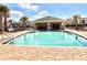 Community pool with comfortable lounge chairs and shady pavilion for resident enjoyment at 2559 Sedge Grass Way, Orlando, FL 32824