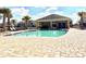 Community pool with comfortable lounge chairs and shady pavilion for resident enjoyment at 2559 Sedge Grass Way, Orlando, FL 32824