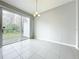 Bright dining area with sliding glass doors leading to the backyard at 2559 Sedge Grass Way, Orlando, FL 32824