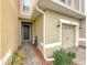 Townhome exterior showing front door and walkway to attached garage at 2559 Sedge Grass Way, Orlando, FL 32824