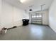 Spacious two-car garage with epoxy flooring, overhead lighting, and an automatic door at 2559 Sedge Grass Way, Orlando, FL 32824