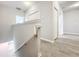 Hallway featuring wood-look flooring, white doors and trim, leading to bedrooms and additional living spaces at 2559 Sedge Grass Way, Orlando, FL 32824