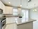 Updated kitchen features stainless steel appliances, granite countertops, a kitchen island, and natural light at 2559 Sedge Grass Way, Orlando, FL 32824