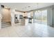 Bright kitchen with stainless steel appliances, granite countertops, kitchen island, and sliding glass doors at 2559 Sedge Grass Way, Orlando, FL 32824