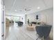 Bright living room with modern furnishings, recessed lighting, and view to open concept kitchen and dining area at 2559 Sedge Grass Way, Orlando, FL 32824