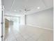Spacious living room with sleek tile flooring, neutral paint, modern lighting, and an open concept layout at 2559 Sedge Grass Way, Orlando, FL 32824