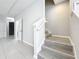 Staircase with modern wooden steps and white banister, leading to the upper level of the home at 2559 Sedge Grass Way, Orlando, FL 32824