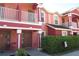 Charming two-story coral townhomes with white railings and well-maintained landscaping at 261 Autumn Ln # 4, Kissimmee, FL 34743