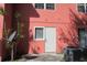 Rear exterior featuring a peach-colored wall, air conditioning unit, and white door at 261 Autumn Ln # 4, Kissimmee, FL 34743